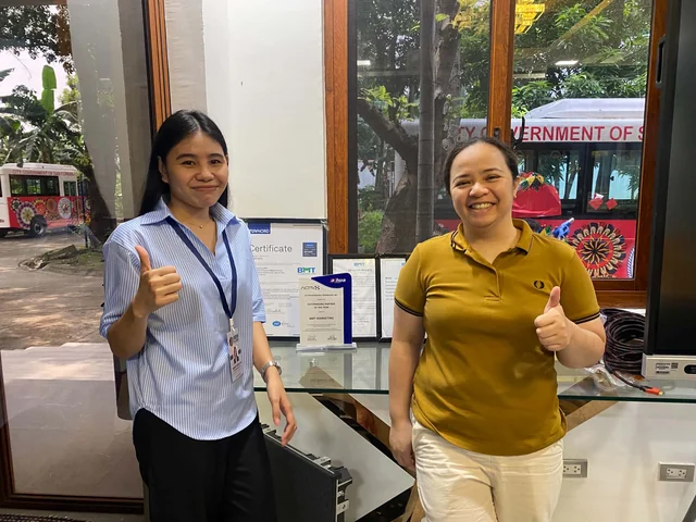 A PGH representative and a client posing together in an office